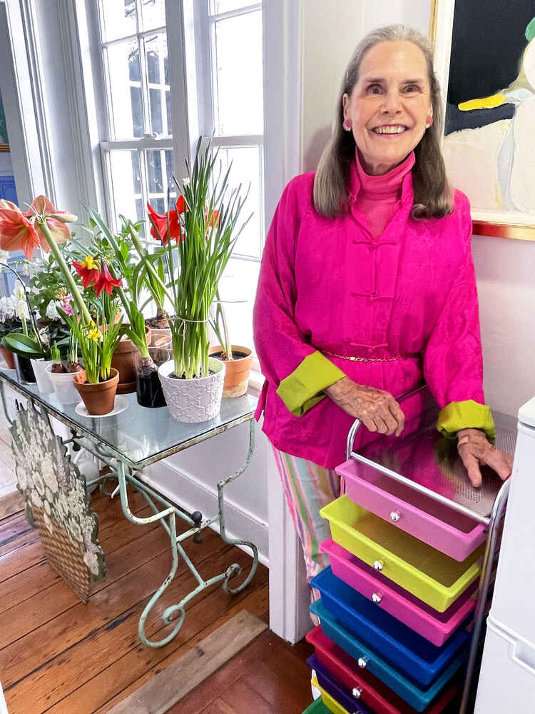 Alexandra standing next to a colorful drawer set. The drawers are empty.