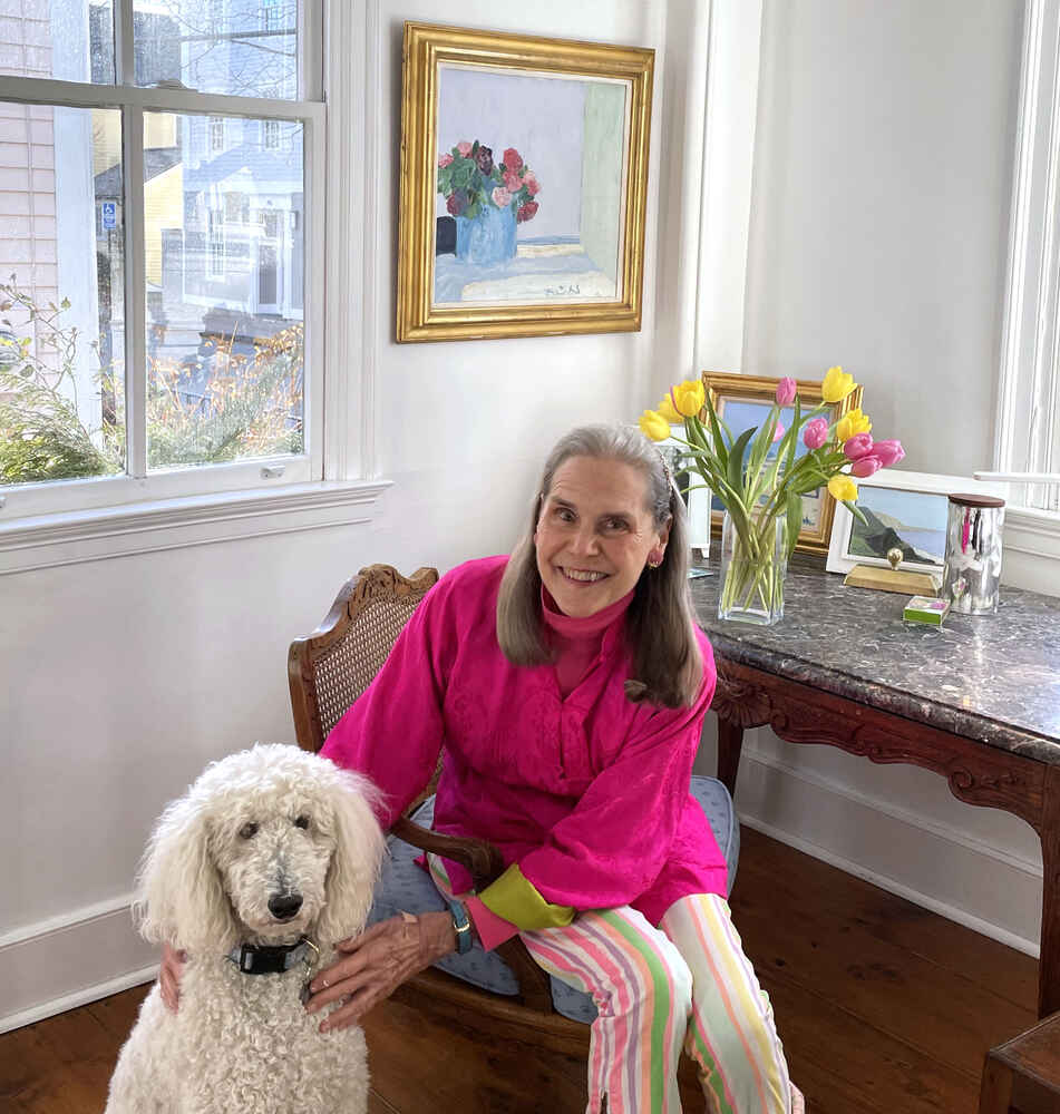 Alexandra with an adorable white fluffy poodle named Scout.