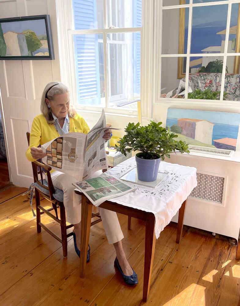 Alexandra reading the newspaper in her living room