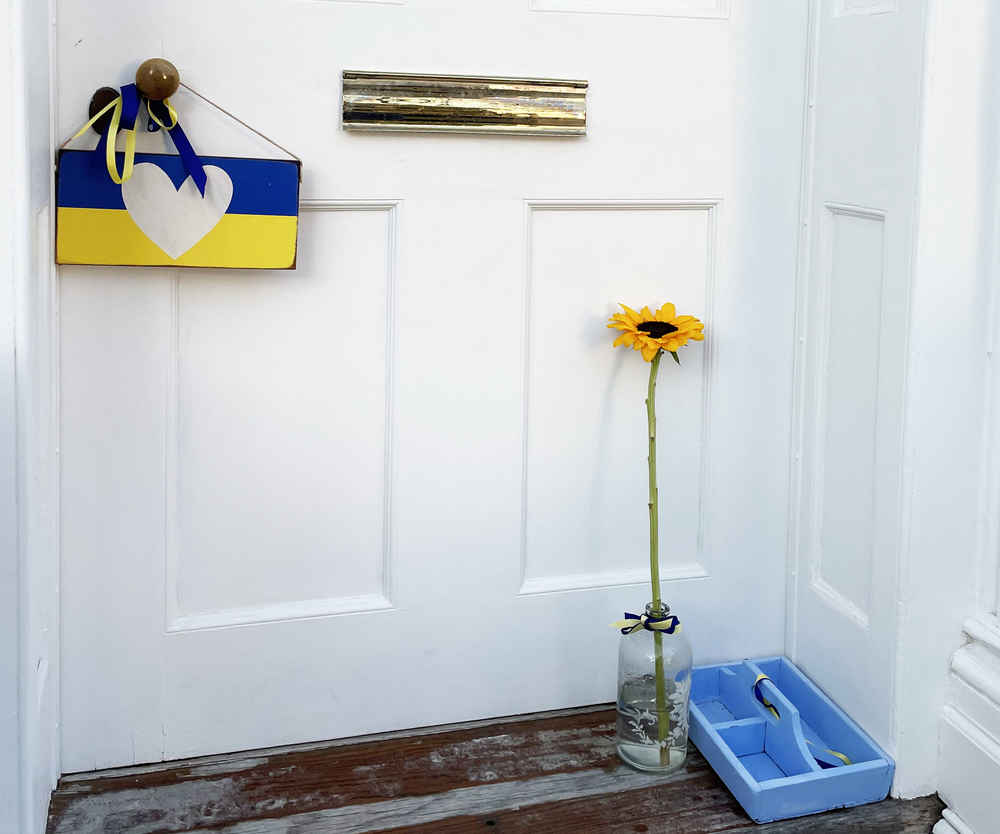 Alexandra's door with a Ukrainian flag plaque with a heart
