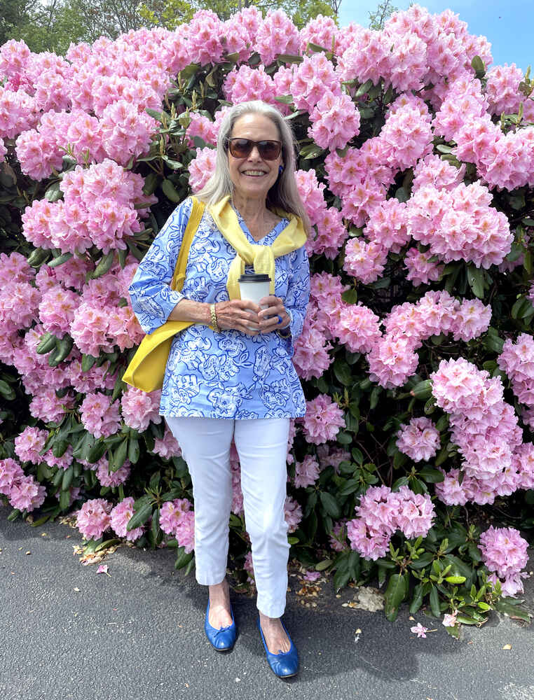 Alexandra in front of a rhododendron bush