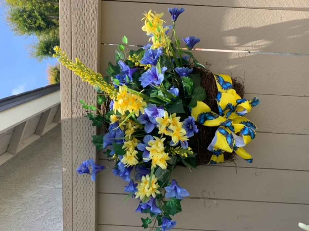 Blue and yellow flowers on a fence