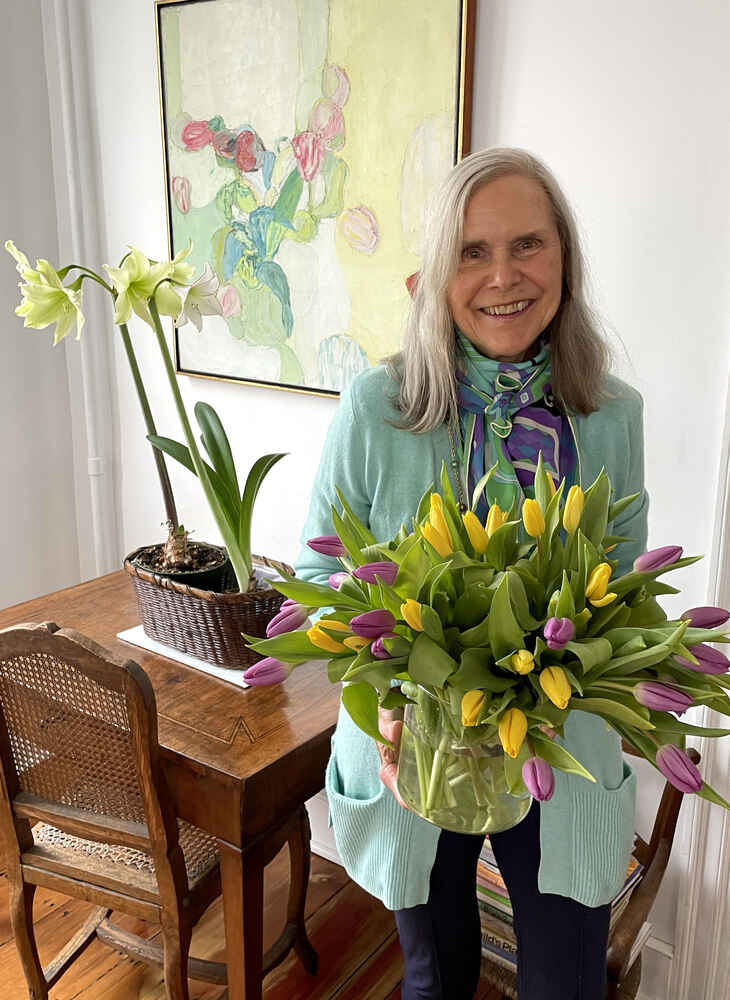 Alexandra with an armful of yellow and purple tulips