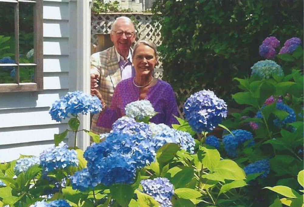 Peter and Alexandra in the garden with hydrangeas in full bloom.