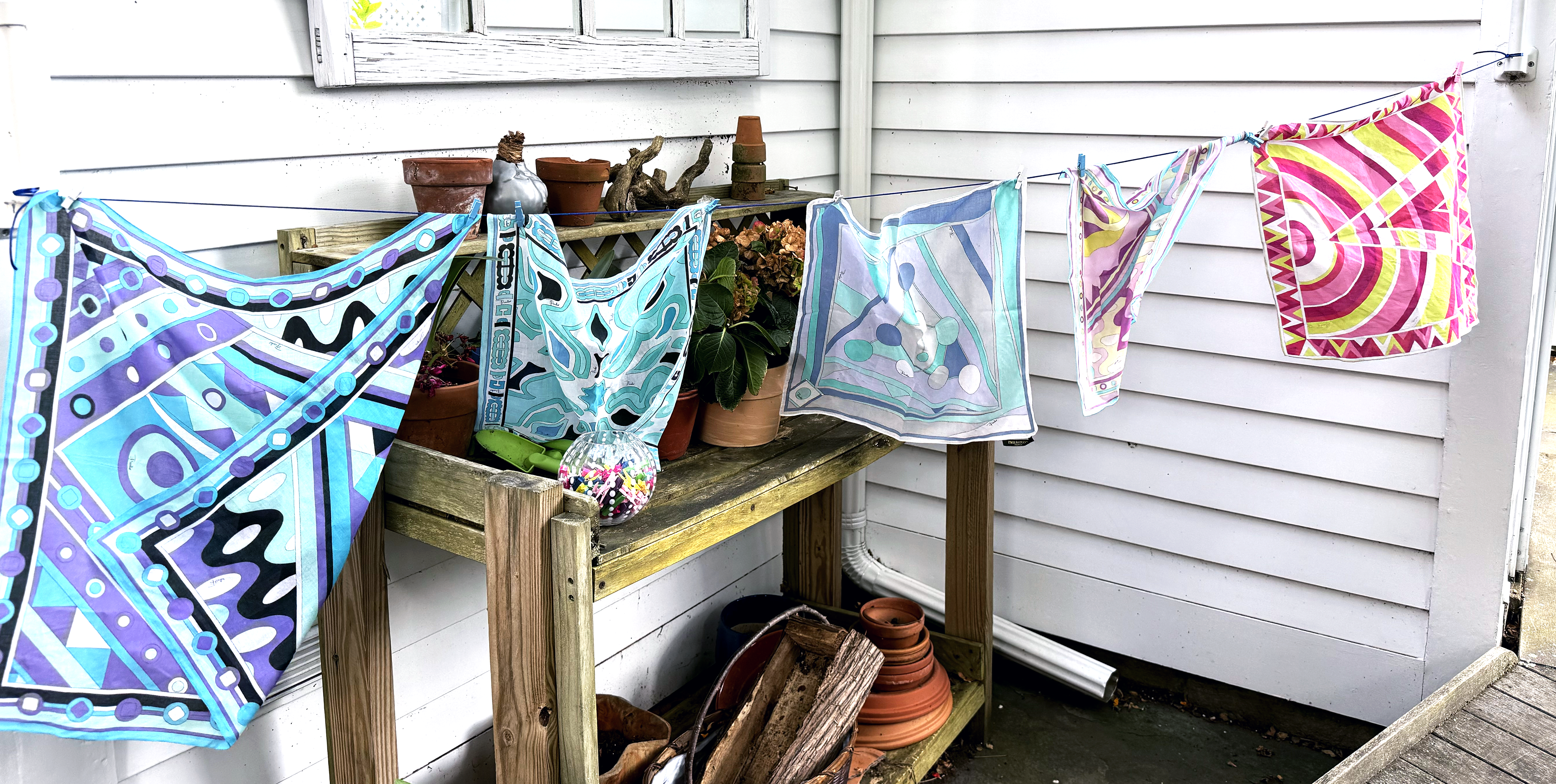 Colorful Pucci scarves hanging on a small clothesline in the garden.
